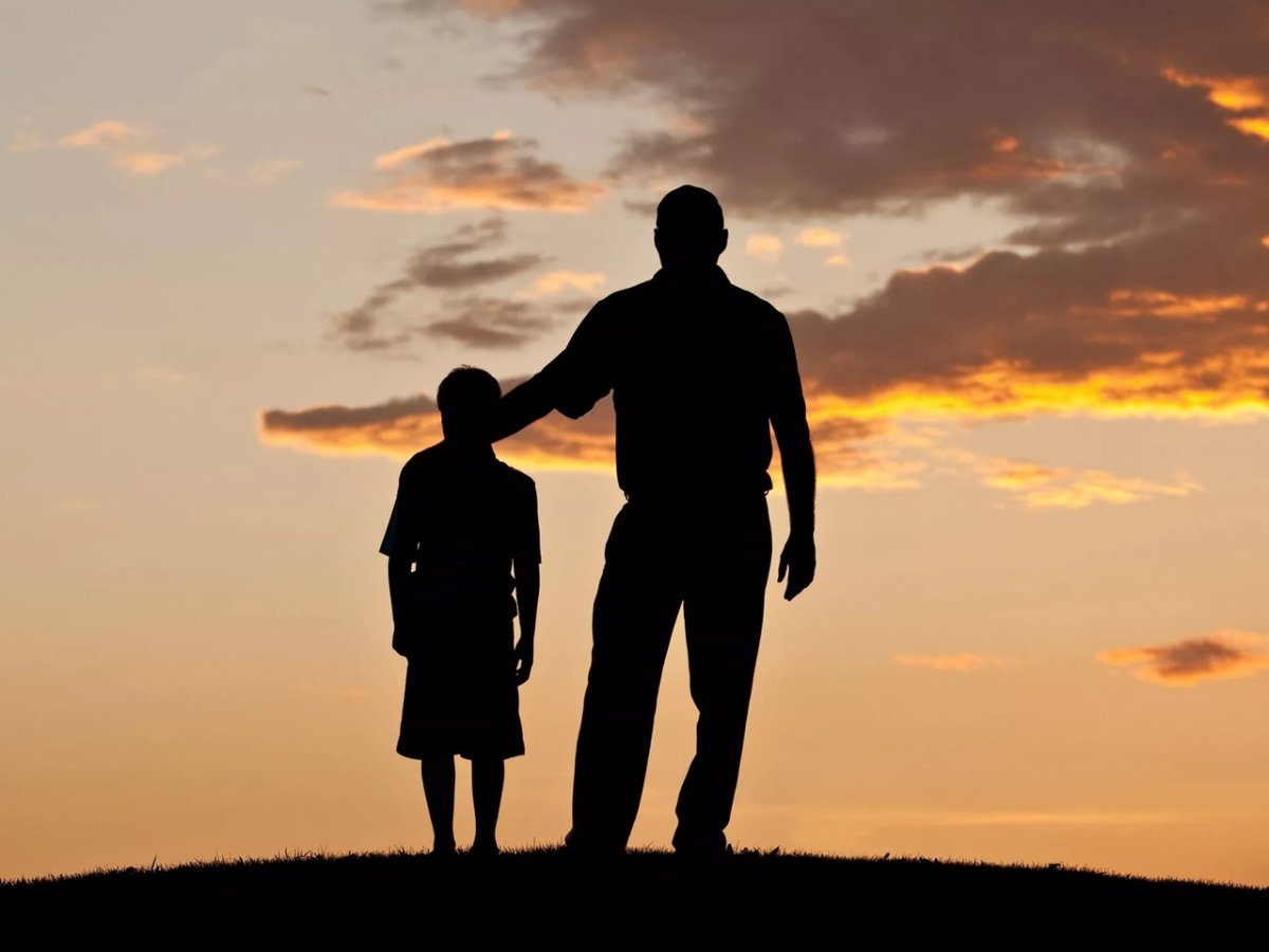 Силуэт мужчины с детьми на закате